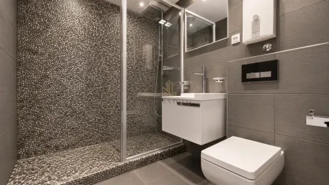 Modernly equipped bathroom with a pebble-tiled shower cabin. - image 12