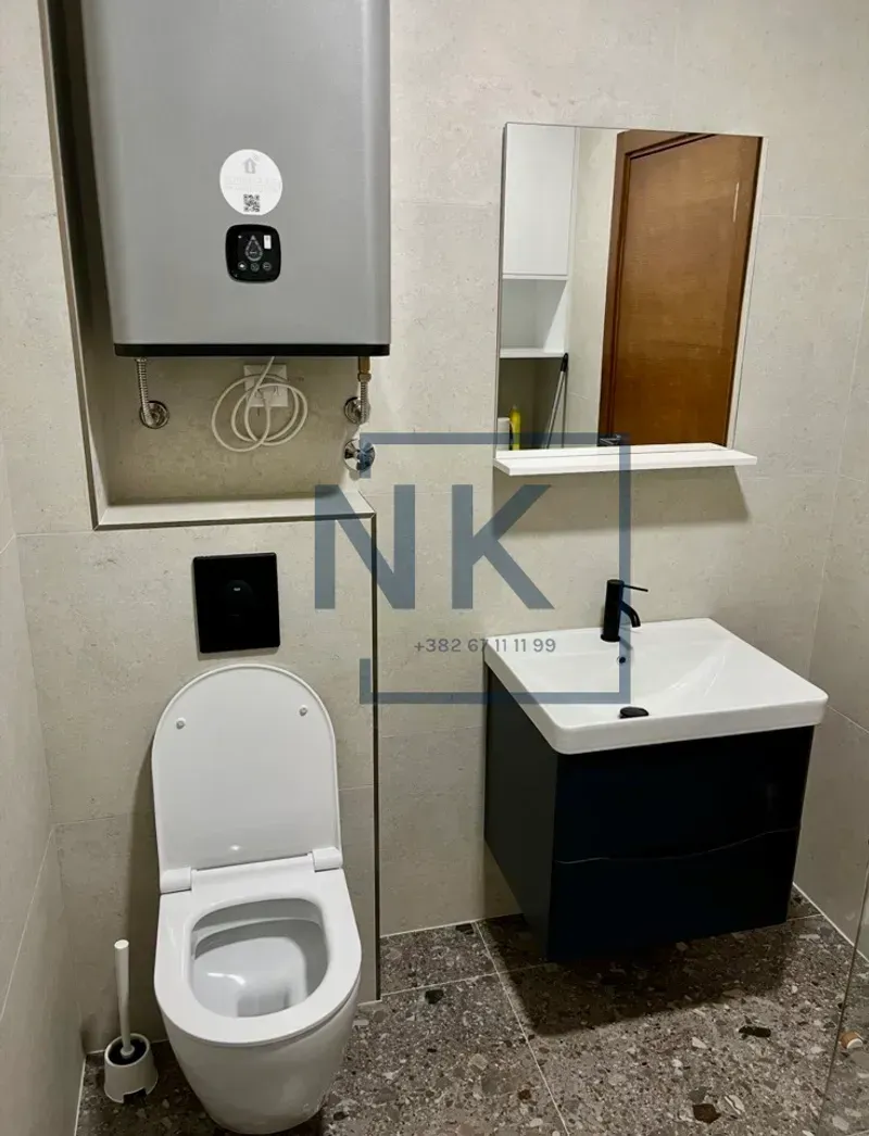 Modernly equipped bathroom with sanitaryware and a water heater.