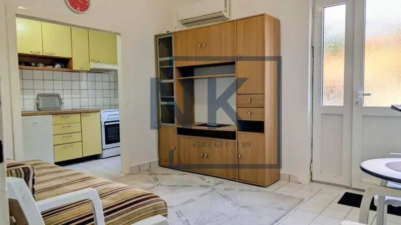 Living room with a sofa set, furniture, and a view of the kitchen.