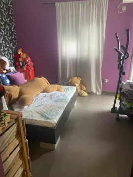Bedroom with a bed, purple walls and toys. - image 7