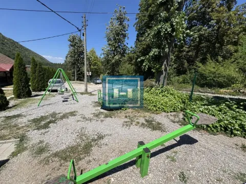 Yard with a children's playground and greenery. - image 21