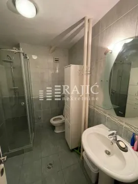 Small tiled bathroom with a shower cabin and a washbasin. - image 12