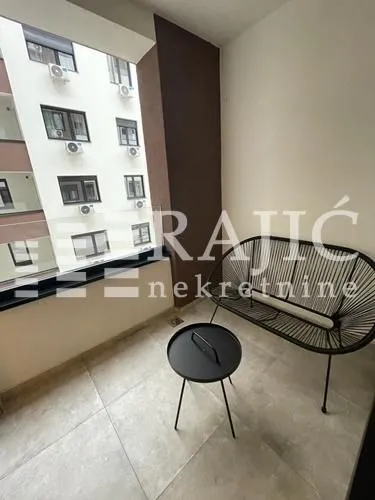 Covered balcony with seating furniture.