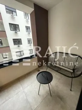 Covered balcony with seating furniture. - image 2