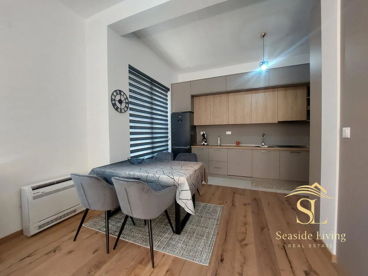 Modern kitchen with a dining area within a bright living space.