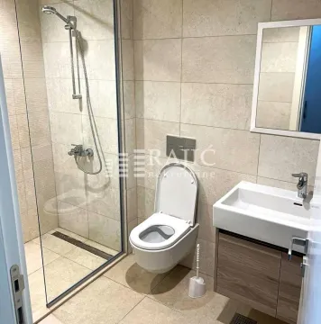Modernly equipped bathroom with a walk-in shower and sink. - image 11