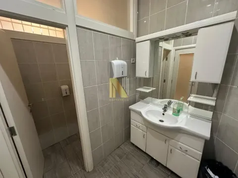 Tiled bathroom with a sink and mirror. - image 11
