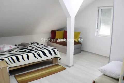 Attic bedroom with a bed and a window. - image 5