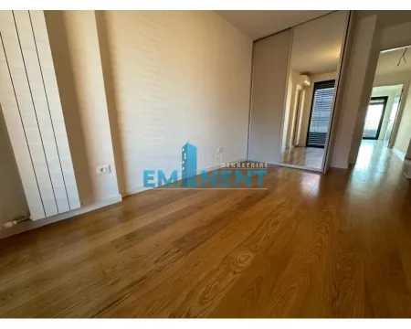 Empty bedroom with wooden flooring and a mirrored built-in wardrobe. - image 11