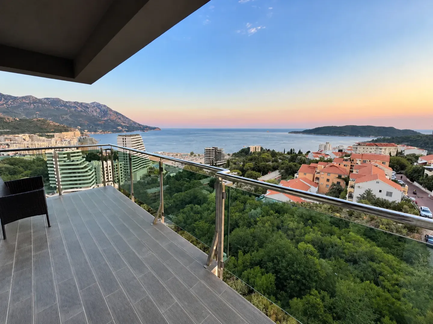 View of the sea, city, and mountains from the balcony.
