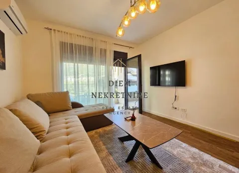Living room with sofa, coffee table and balcony access. - image 2