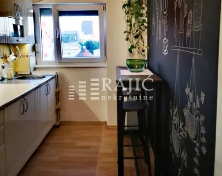 Smaller kitchen with a dining table and window. - image 5