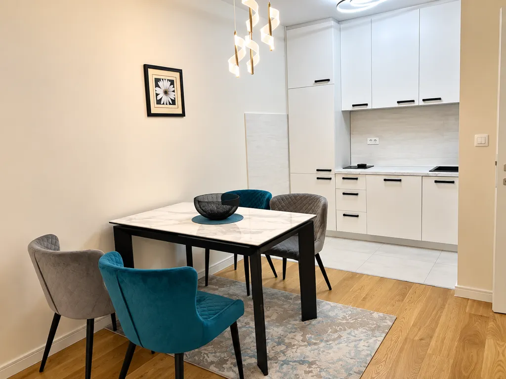 Modern kitchen with a dining table and chairs.