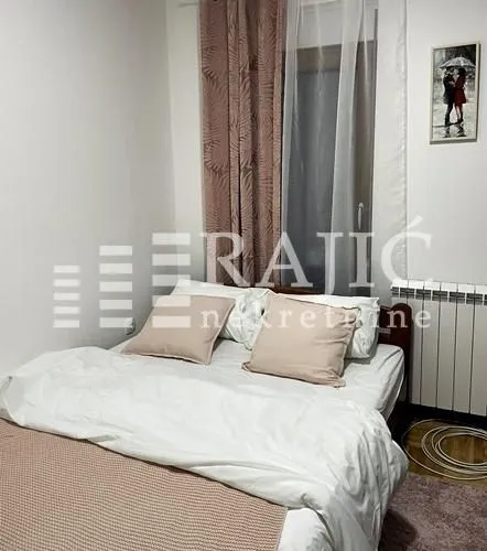Furnished bedroom with a double bed.