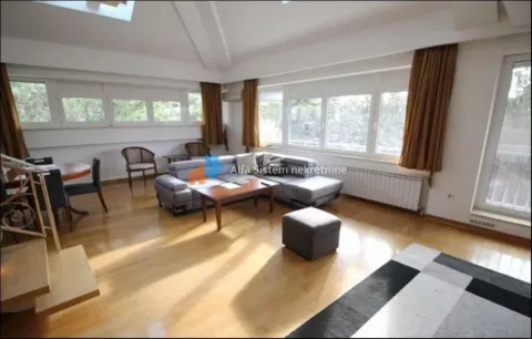 Spacious living room with a sofa set, wooden flooring, and large windows. - image 10