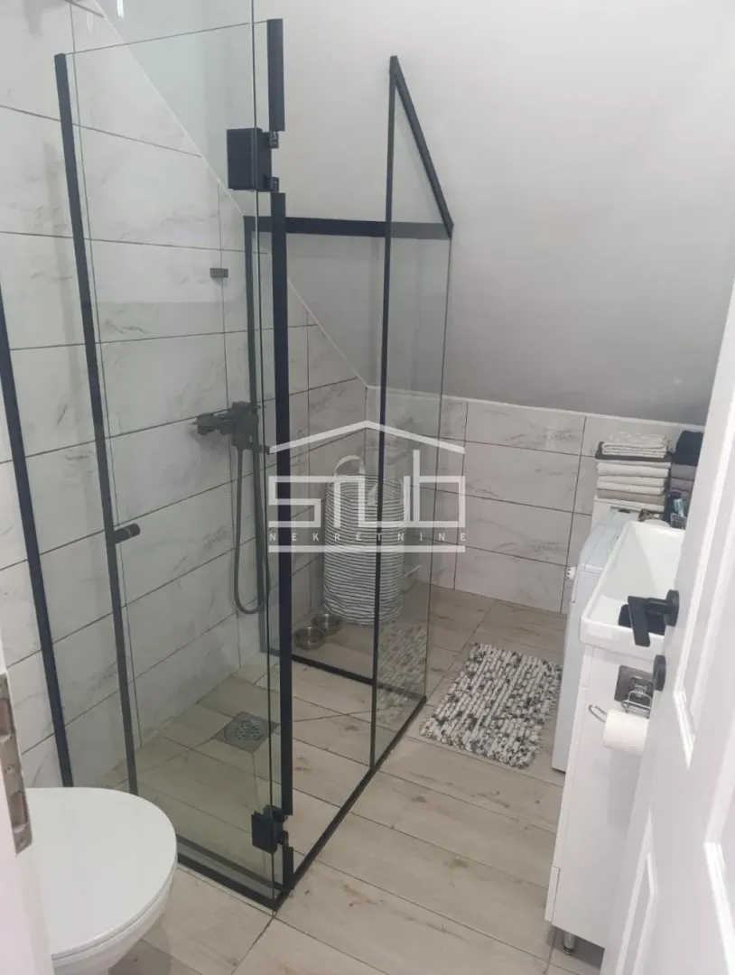 Modernly equipped bathroom with a walk-in shower.