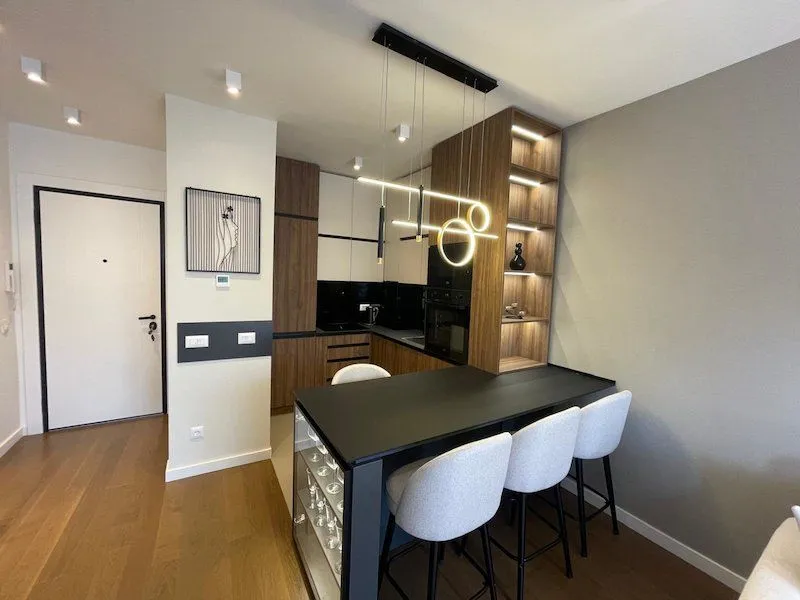 Modern kitchen with a breakfast bar and dining table.