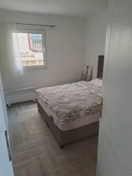 A view of the bedroom with a double bed and a window. - image 8