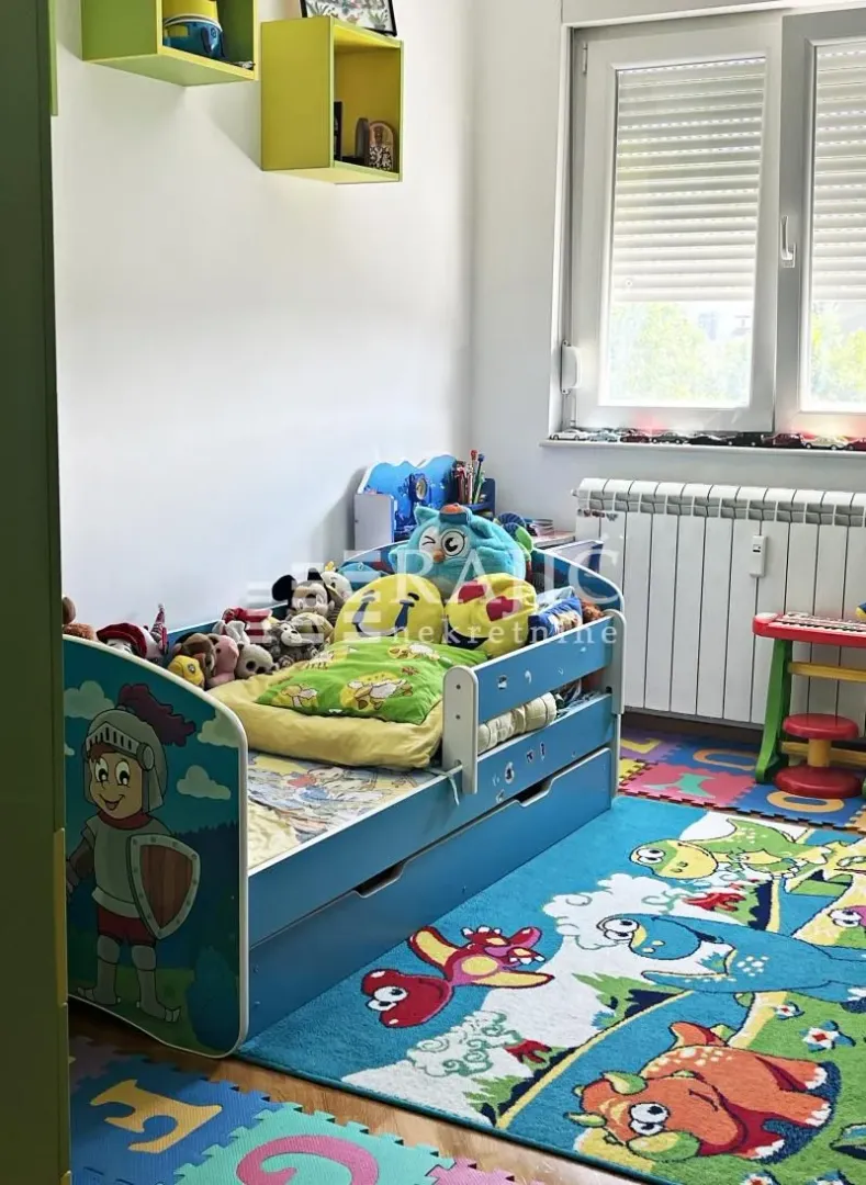 Children's bedroom with a bed and colorful toys.
