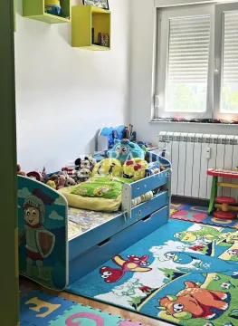Children's bedroom with a bed and colorful toys. - image 6