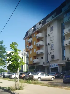 Spoljašnjost višespratne stambene zgrade sa parkingom ispred. - image 10