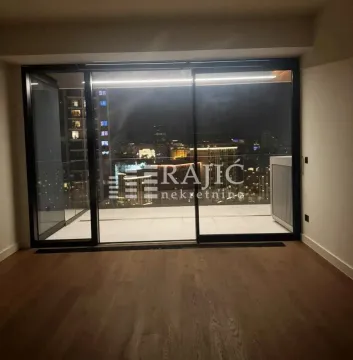 Living room with large glass panels and a night city view. - image 5