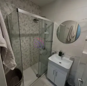 Moderne kupatilo sa tuš kabinom, umivaonikom i okruglim ogledalom. - image 2