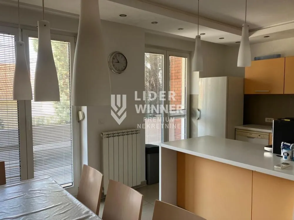 Kitchen with a breakfast bar and dining table in an apartment.