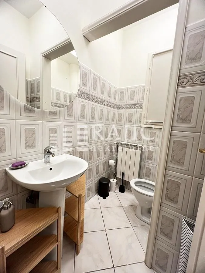 Small bathroom with a sink, mirror, and toilet.