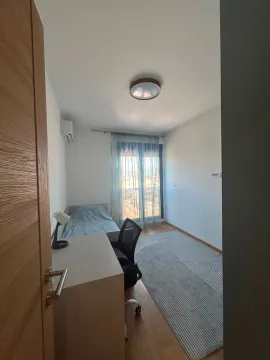 Small bedroom with a bed, desk, and window. - image 6