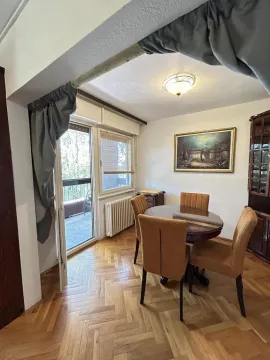 Dining area with a round table and chairs, with access to the balcony. - image 6