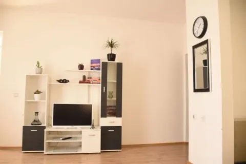 Living room with a TV unit and shelves. - image 2