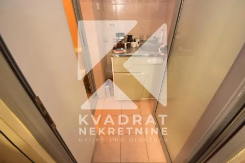 Small kitchen with a sink and kitchen units, photographed through a glass door. - image 3