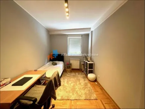 Small bedroom with a bed, desk, and a window. - image 8
