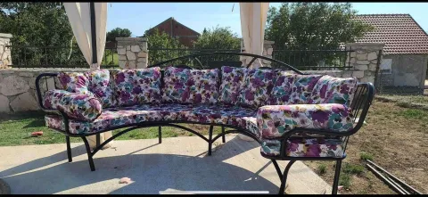 Yard with seating furniture under a canopy. - image 9