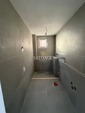 Bathroom under renovation tiled with grey tiles and prepared plumbing installations. - image 8