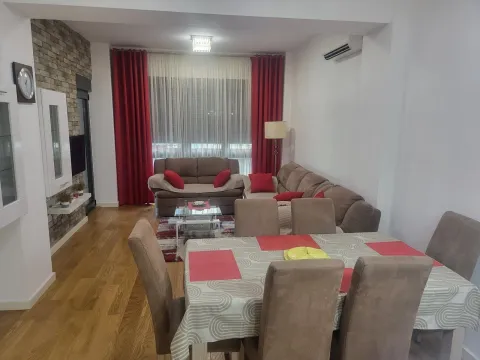 Bright living room with a dining table and sofa set. - image 4