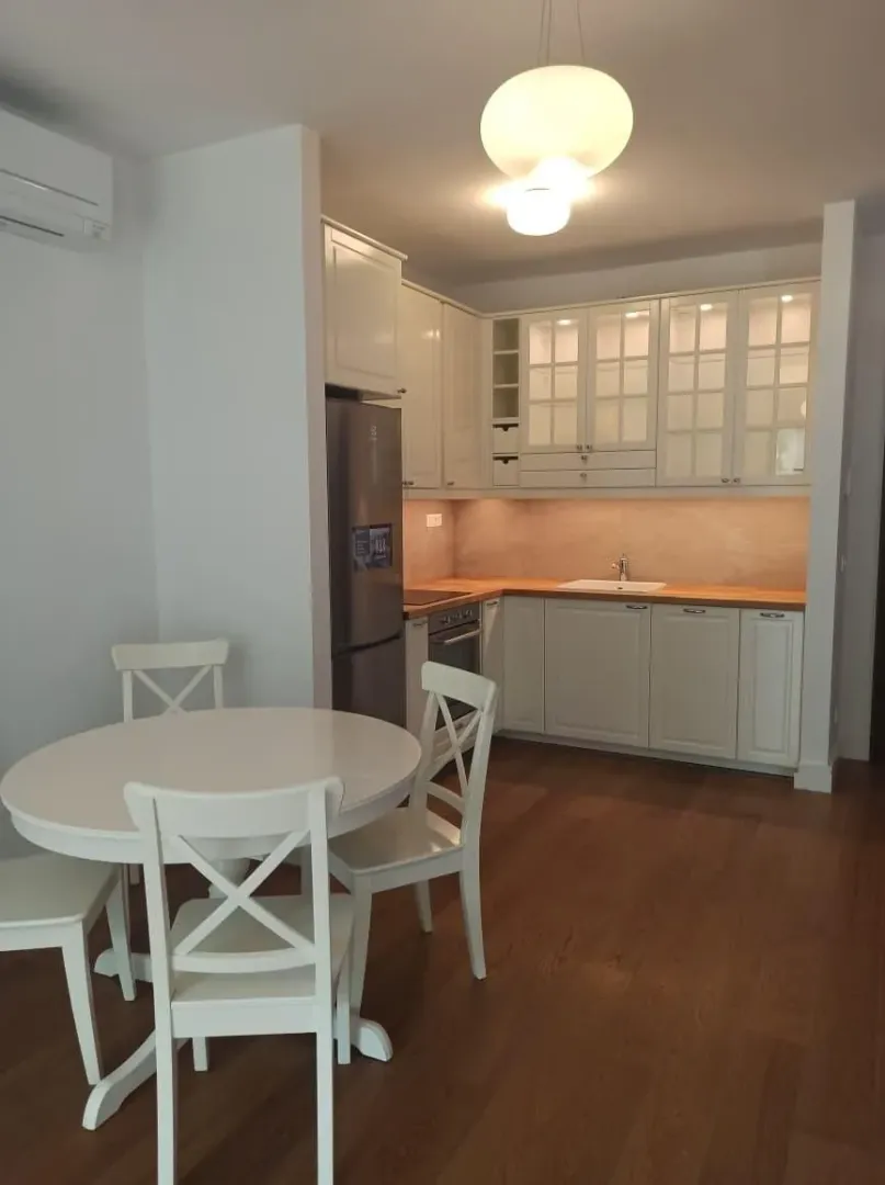 Kitchen with dining area and white cabinets.