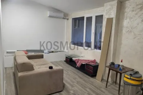 Smaller living room with a sofa and TV cabinet during renovation. - image 10