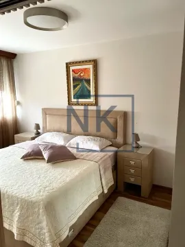 Furnished bedroom with a double bed, nightstands, and a painting on the wall. - image 7