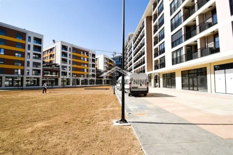View of the exterior of the residential complex with a landscaped yard and sidewalk. - image 15