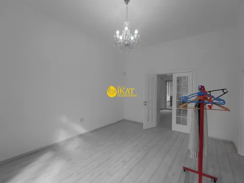 Empty room with white walls, light wooden flooring and a chandelier on the ceiling. - image 7