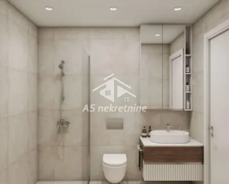 Moderno opremljeno kupatilo sa tuš kabinom, umivaonikom i WC šoljom. - image 9