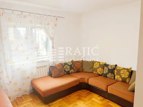 Living room with a sectional sofa and a window. - image 9