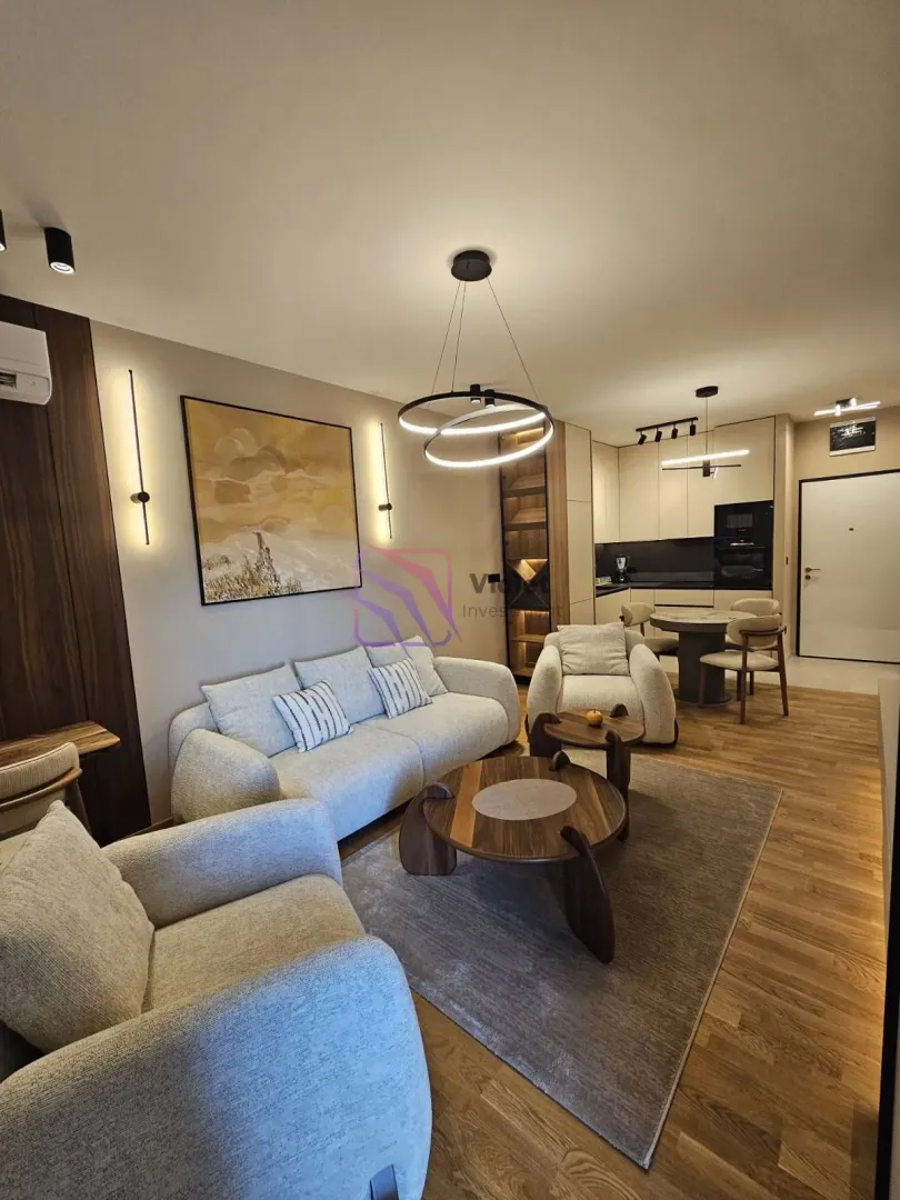 Modern living room connected to the dining area and kitchen.