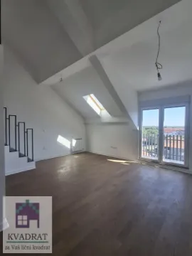 Empty attic room with wooden flooring, sloped ceiling, and balcony doors. - image 4
