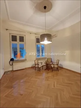 Spacious living room with hardwood flooring, seating furniture, and two windows. - image 14