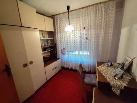 Furnished bedroom with wardrobes, a desk, and a window covered with curtains. - image 17