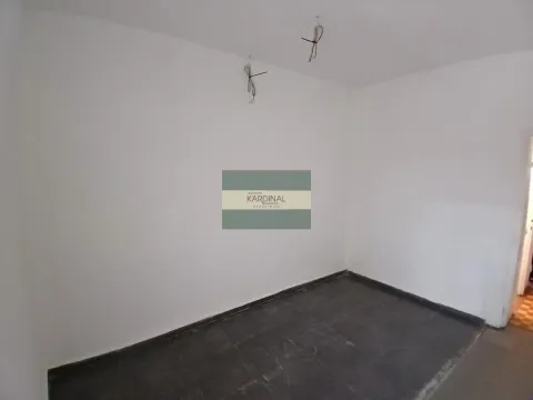 Empty room with white walls and dark floor tiles. - image 2