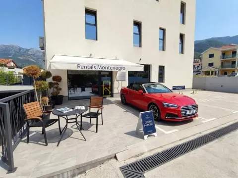Exterior of a commercial building with parking and a terrace. - image 8
